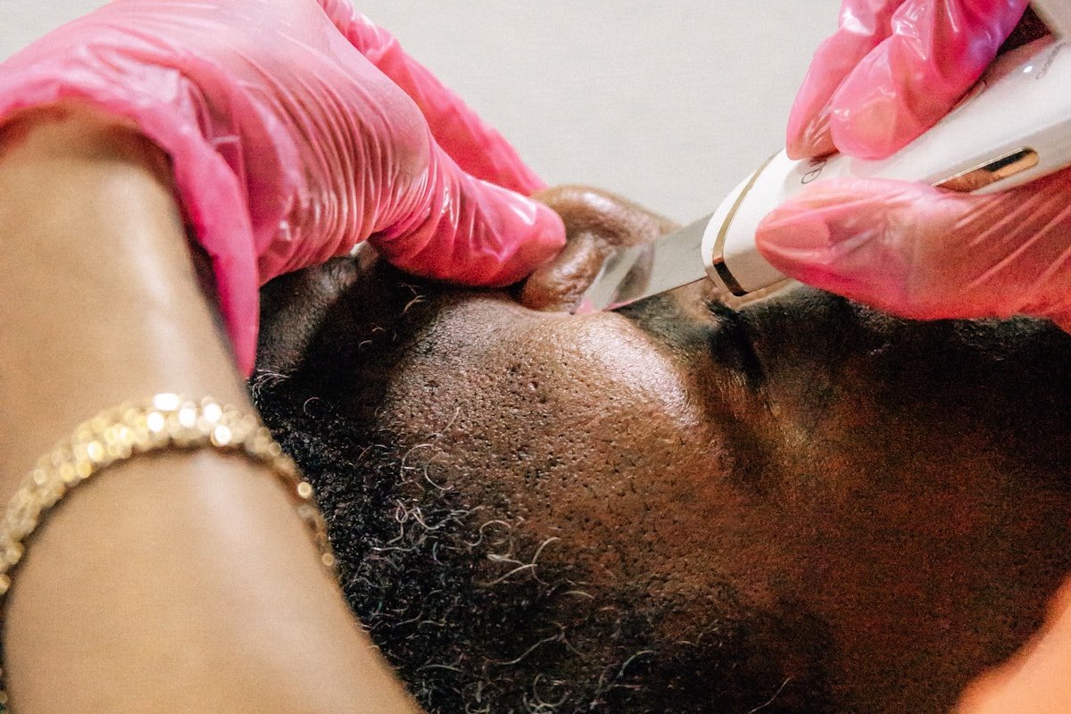 Black client receiving a professional barber grooming service